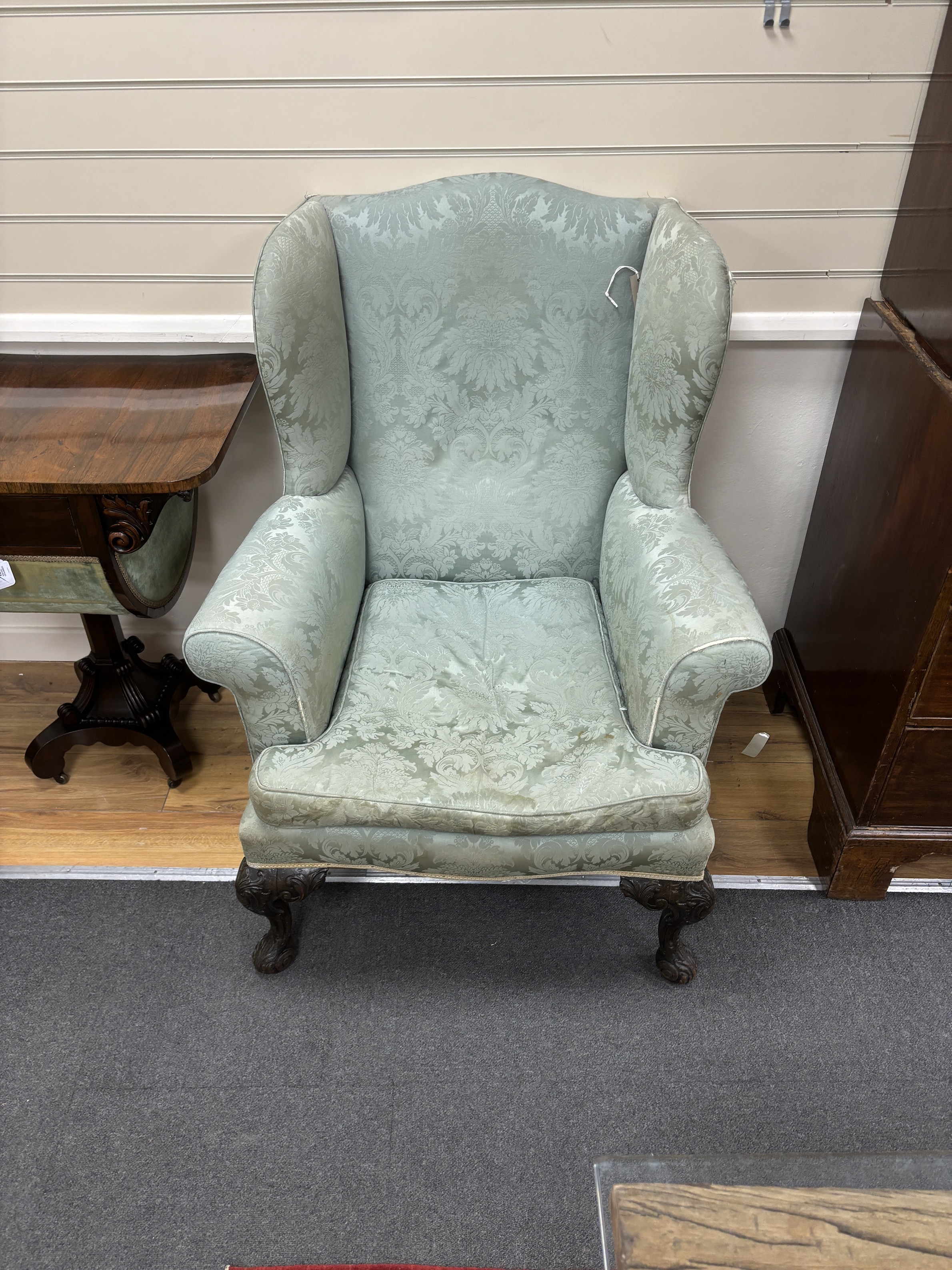 An early 20th century George III style upholstered wing armchair, width 82cm, depth 74cm, height 110cm